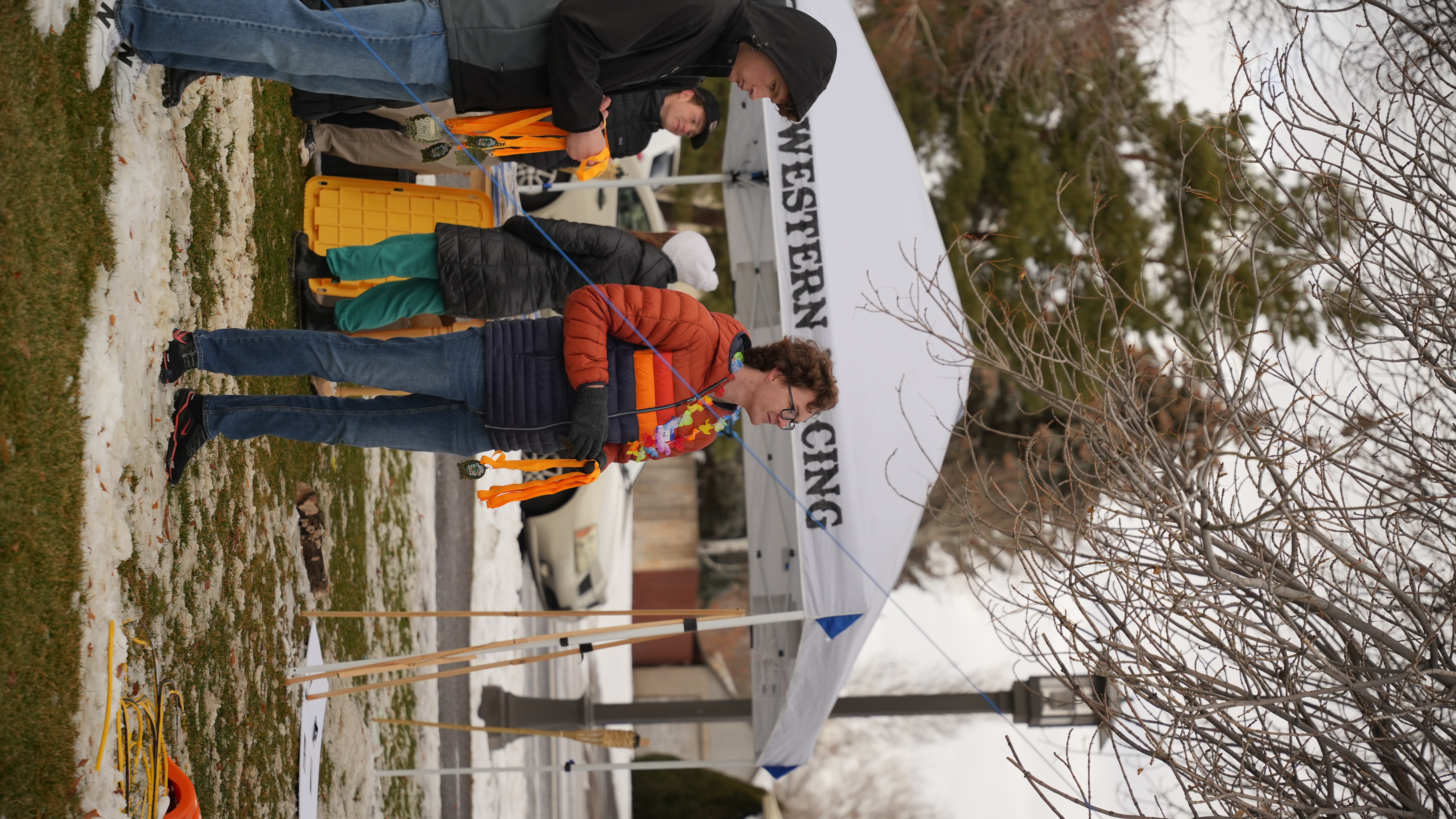 officials waiting at the finish with medals