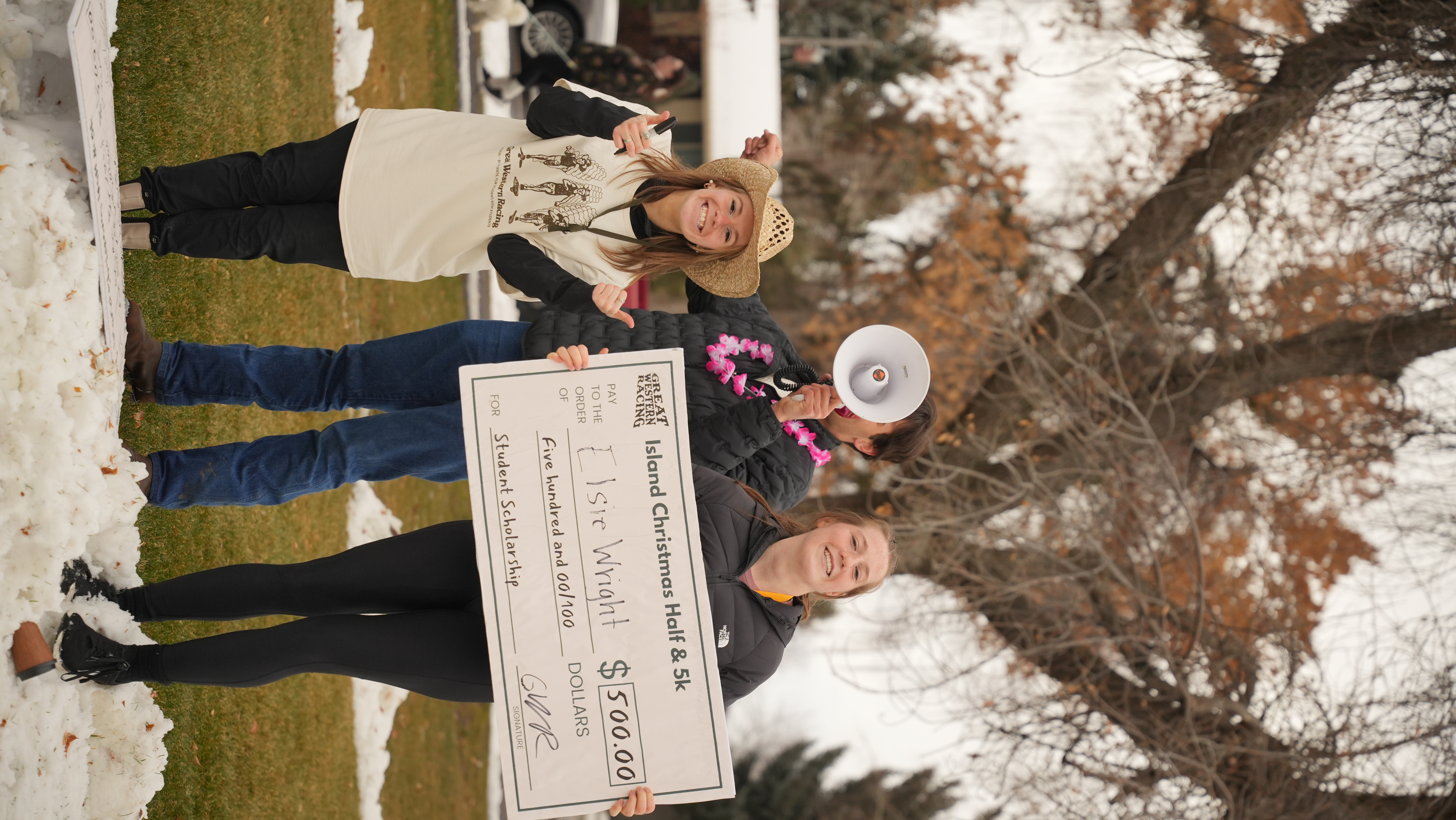 girl holding a comically large check for scholarship