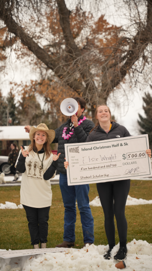 girl holding a comically large check for scholarship